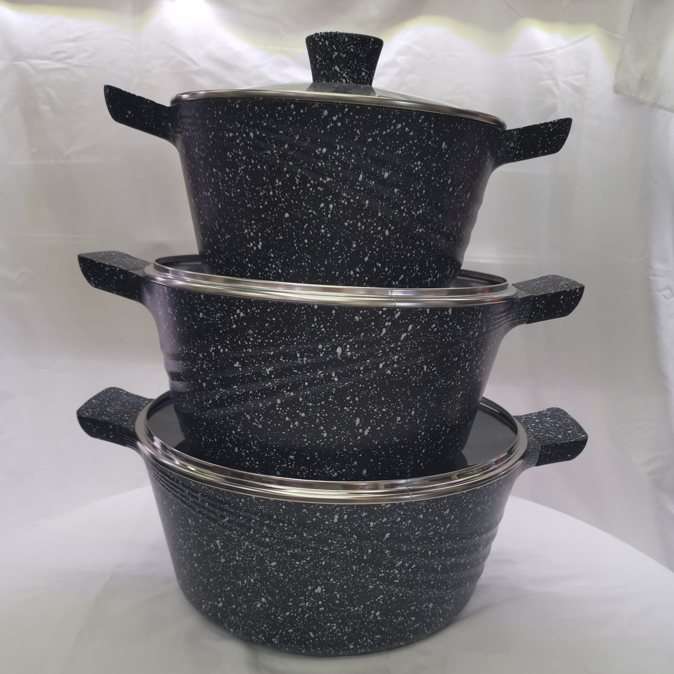 A large six-piece striped soup pot set