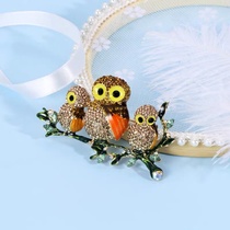 Three owl brooches