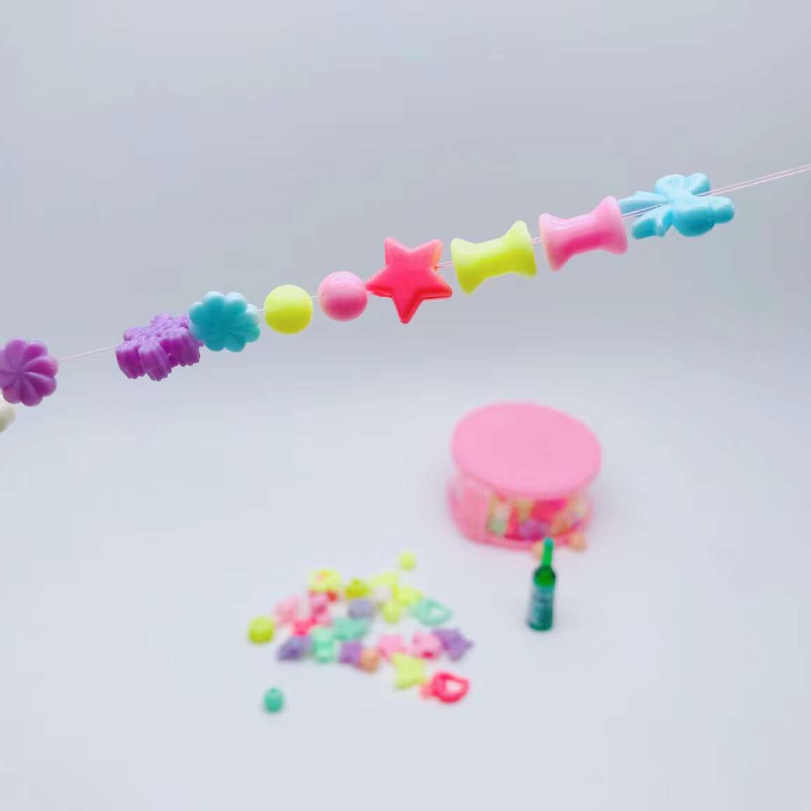 Children string their own bracelets and necklaces