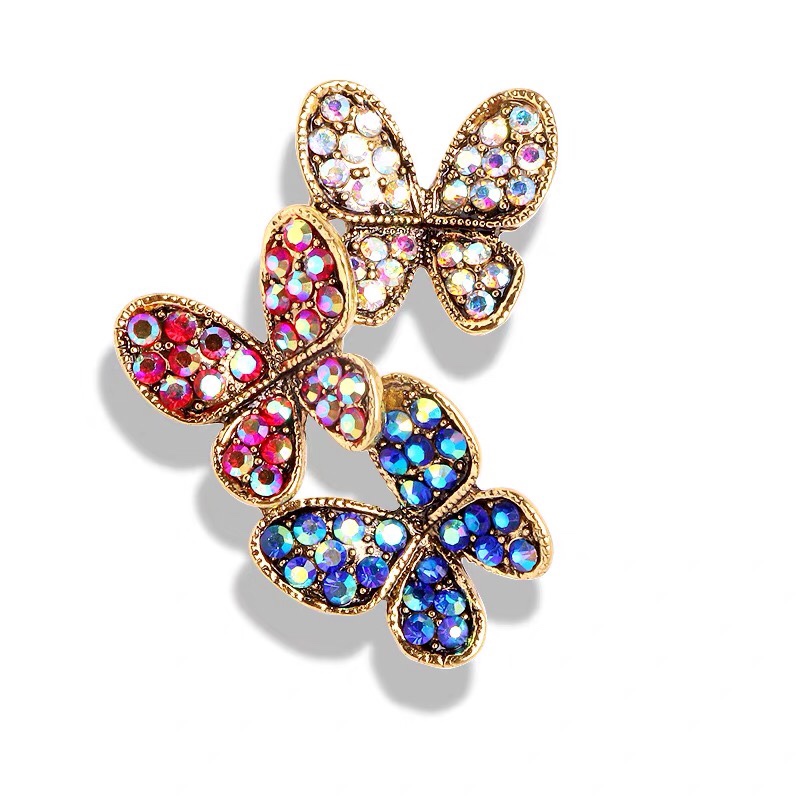 Three butterfly brooches