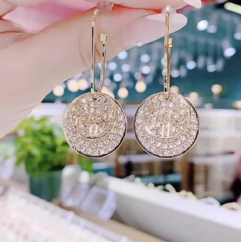 A woman with double round earrings
