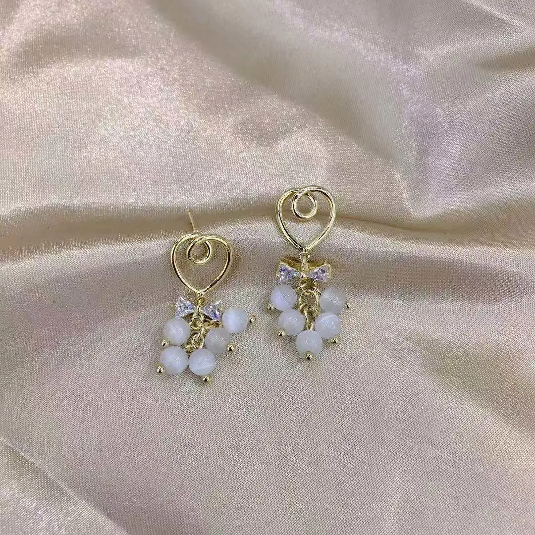 Dongdaemun, South Korea, fashionable and exquisite cat's eye stone earrings for women, new silver needle bow, fresh and individual style earrings detail image 2