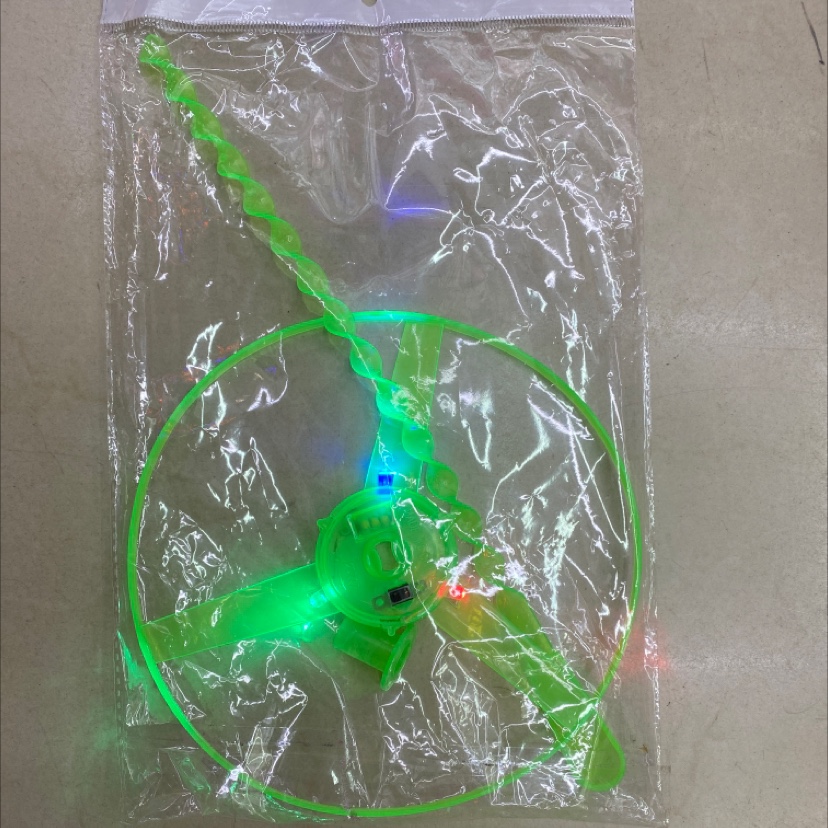 A luminous flying saucer with a string