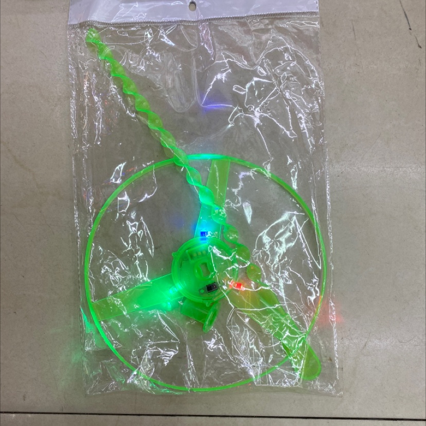 A luminous flying saucer with a string details Picture