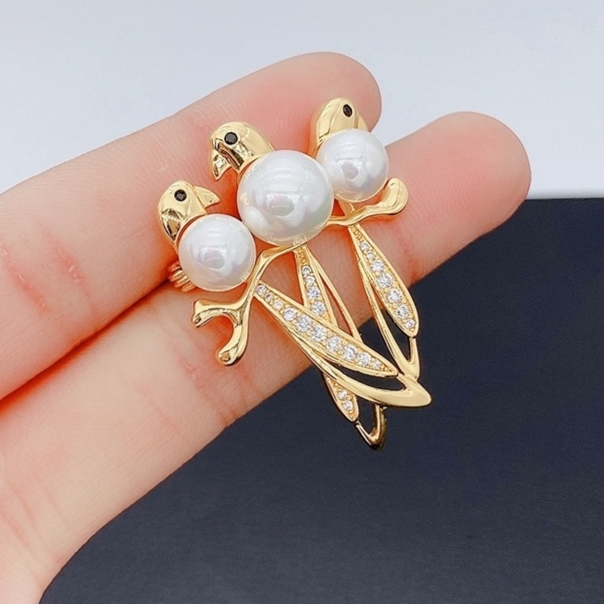 Three magpie brooches