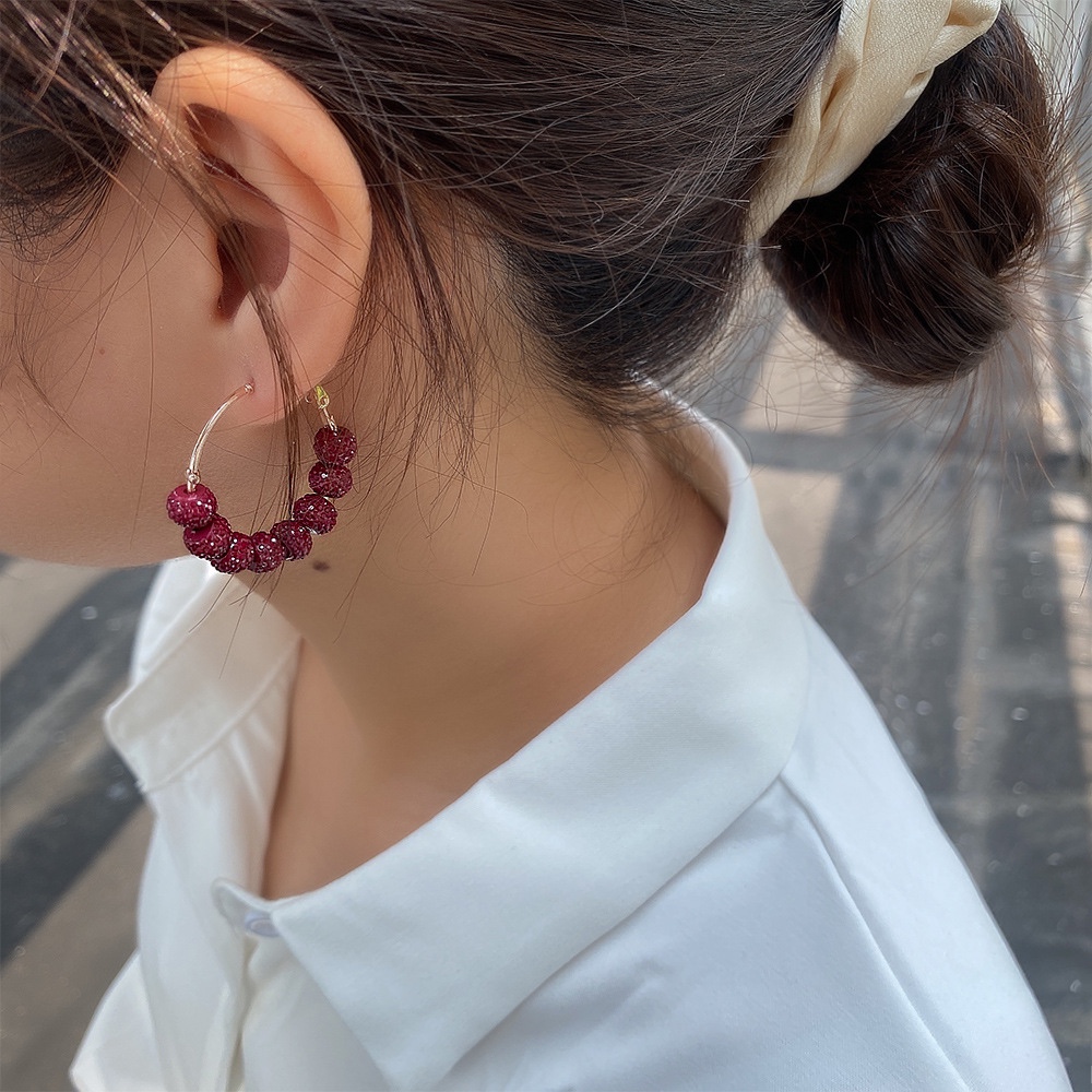 Colorful beaded metal earrings, fashion trend.