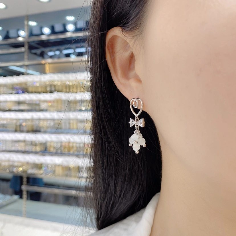 Dongdaemun, South Korea, fashionable and exquisite cat's eye stone earrings for women, new silver needle bow, fresh and individual style earrings detail image 1