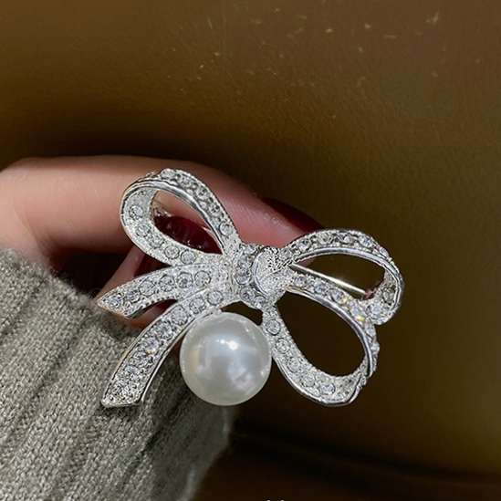 Silver bow tie hanging brooch