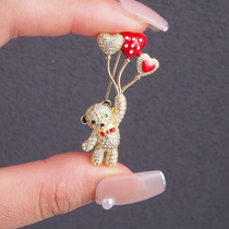 Little Bear plays with balloon brooches