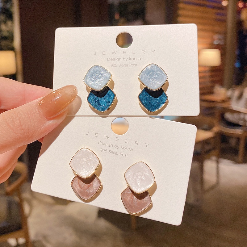 Two drip earrings, warm tones, classic everything.