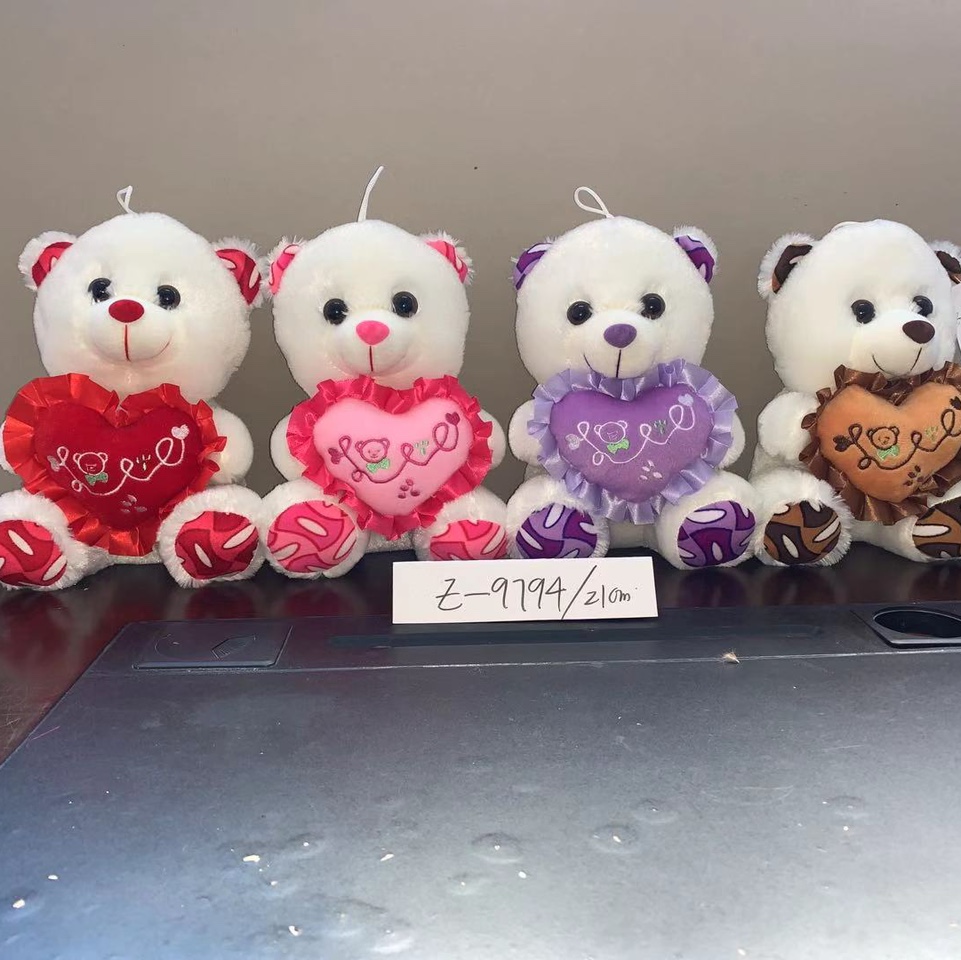 A little head hugging a heart bear