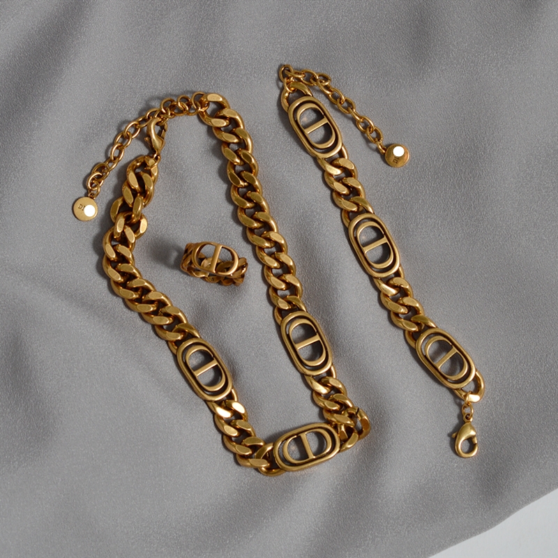 A three-piece set of chain letter necklace, bracelet and ring, with a high-end, retro and aged metal style. It's a trendy collarbone chain