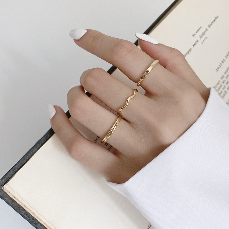 A fashionable women's ring with a thin gold ring and a plain design, combined with a simple silver ring