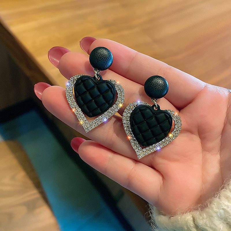Black leather rhinestone earrings, the trend front.
