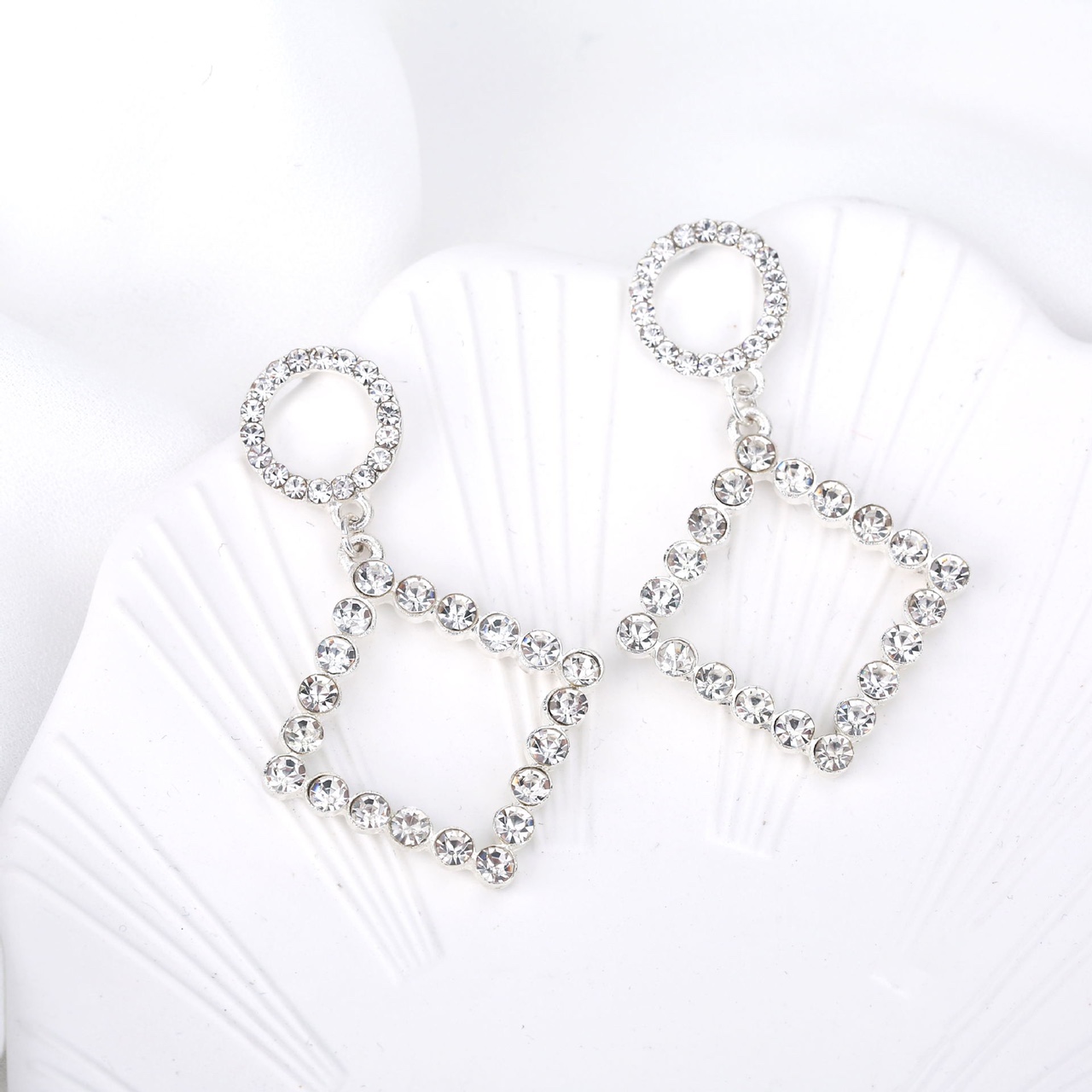 Geometric shapes full of diamond earrings, sparkly.
