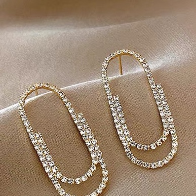 Paper clips full of tiny zirconium earrings