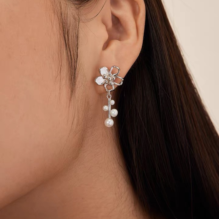 Flowers hang with multiple pearl earrings