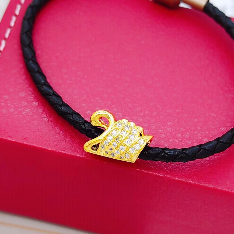 Microencrusted zircon swan across accessories, bracelet and necklace look good together full figure