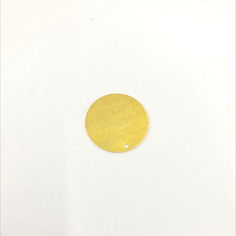 Solid flat disc with one hole embossed on one side