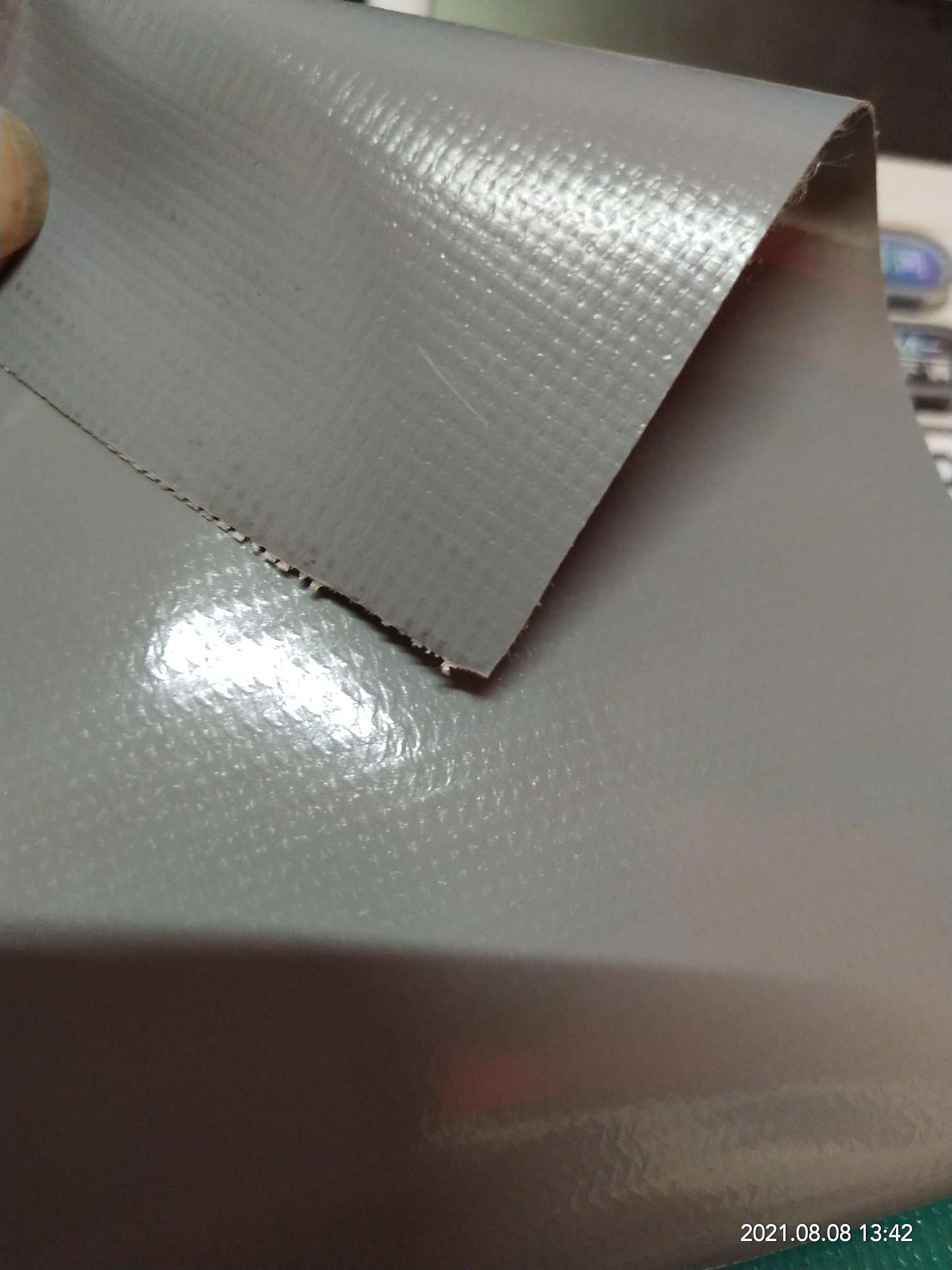 High-quality glossy 0.5mm thick grey PVC mesh fabric for luggage, machine covers, furniture covers, sports and amusement products, and various types of luggage details Picture
