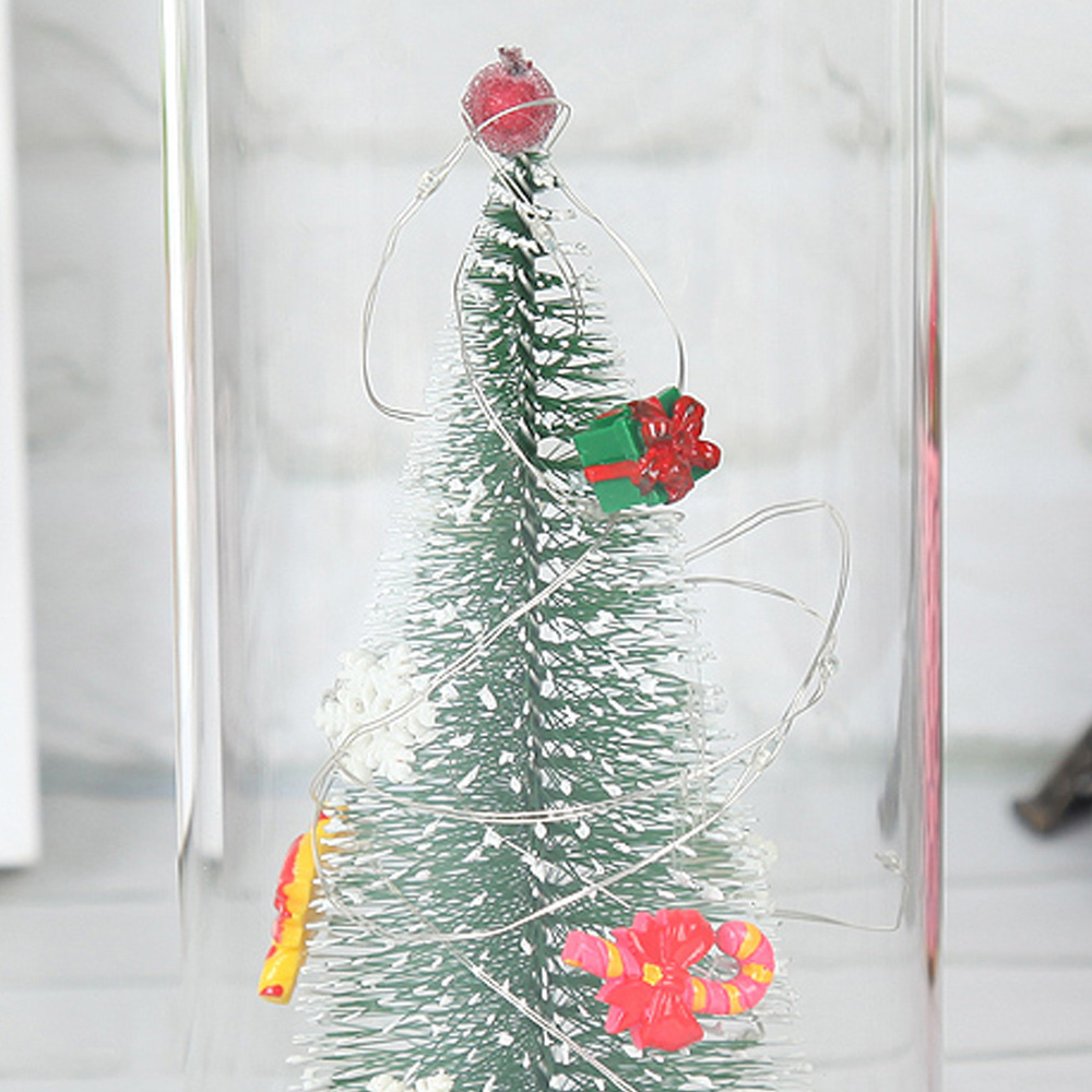 A large artificial Christmas tree with a transparent dust-proof glass cover is a home decoration for the living room and bedroom Application Scenario