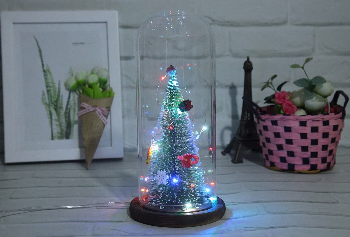 A large artificial Christmas tree with a transparent dust-proof glass cover is a home decoration for the living room and bedroom detail image 3