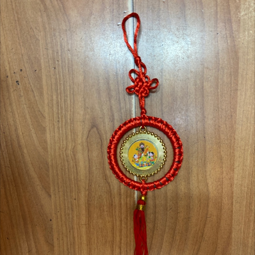 a Pendant red circle Fortune boy statue