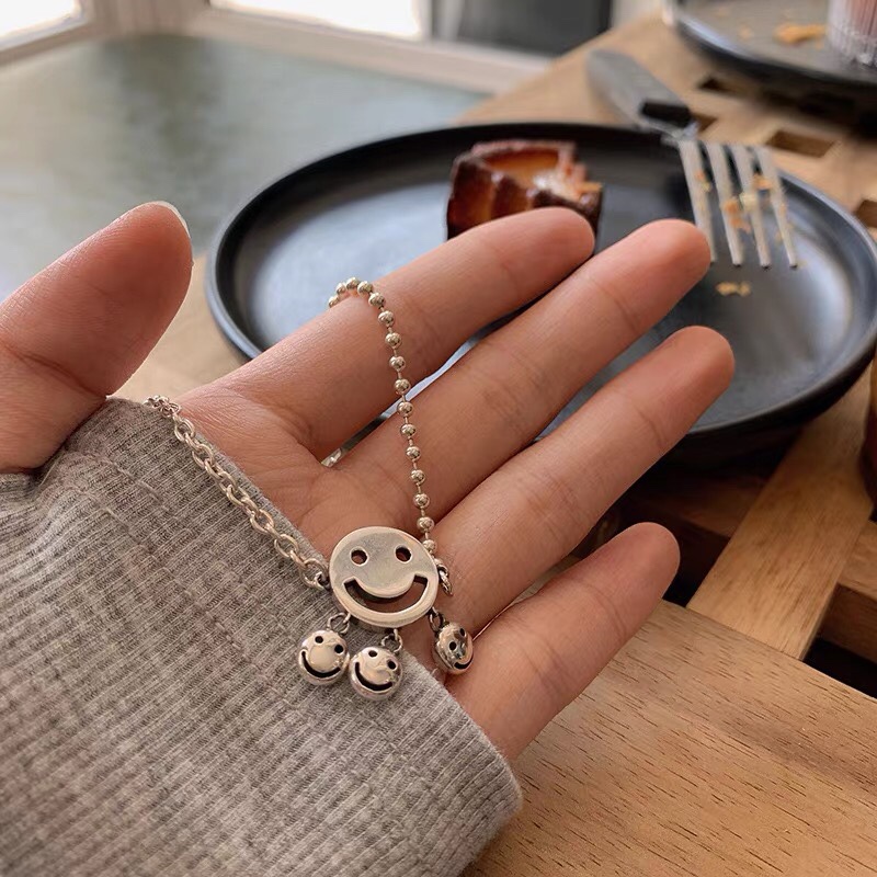 The bell smiley face necklace collarbone chain features a light luxury hip-hop personality design and a fresh look