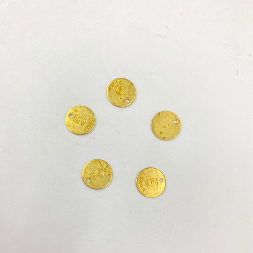 XH04076 Letters 5 are printed in one hole on the flat surface of a solid disk