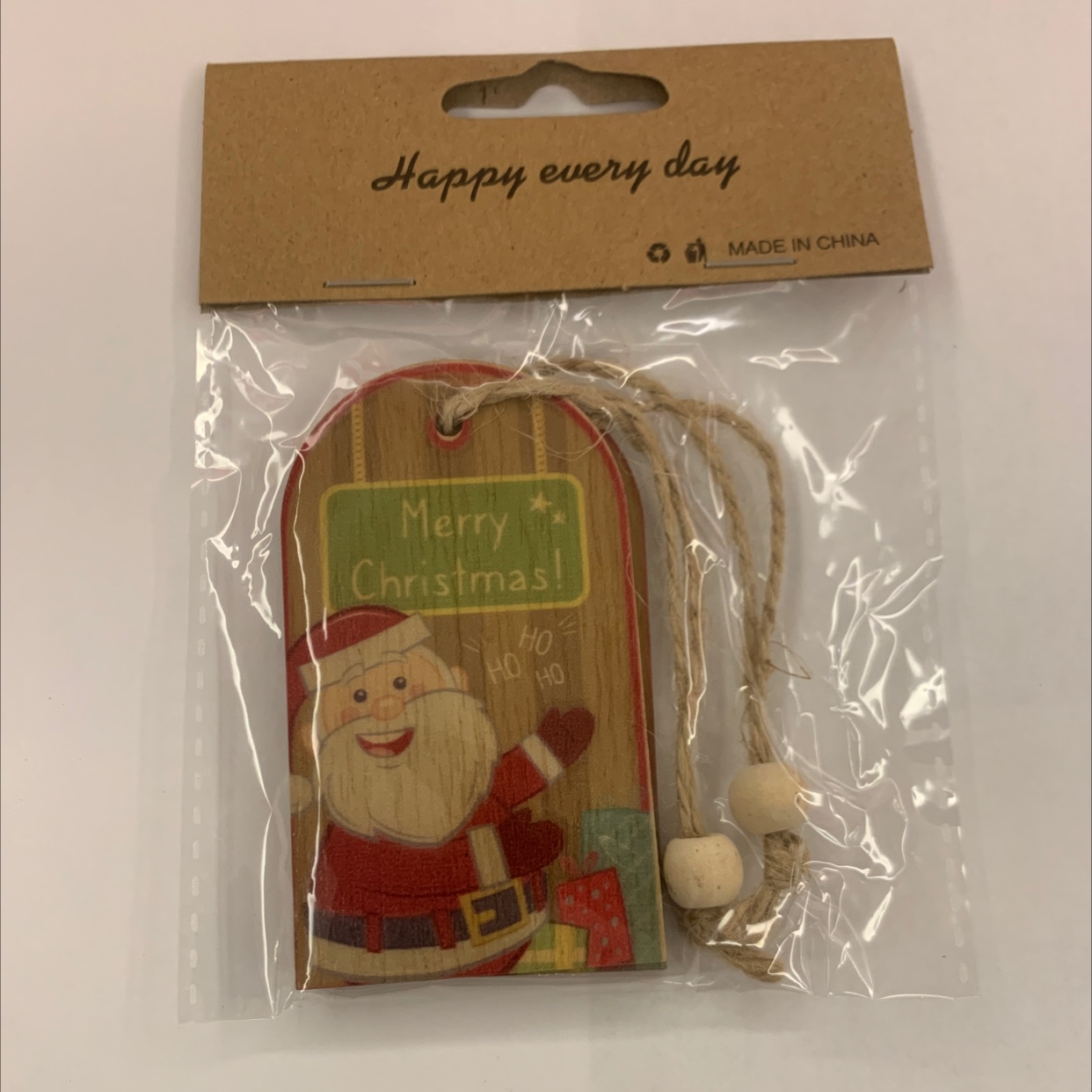 Grey background with color-printed Christmas hemp rope, two strings of natural wood-colored wood beads, one package, gift decoration, wooden 101