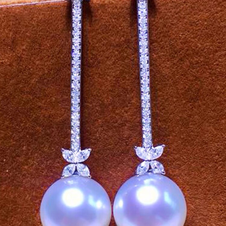 White pearl earrings set with diamond pearl drops