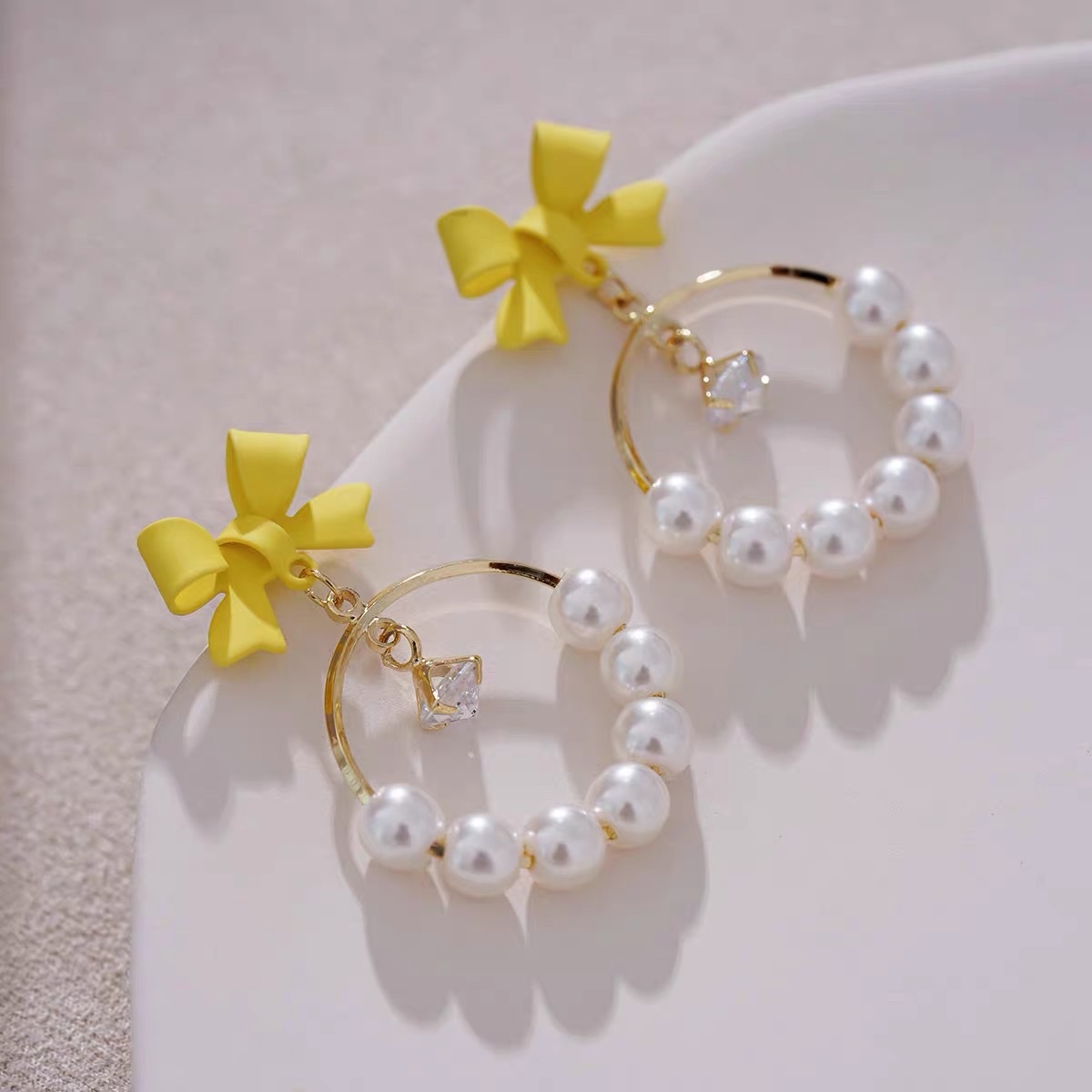 Light yellow bow ear earrings with a unique design sense, French retro and high-end style, Jieya steel jewelry details Picture