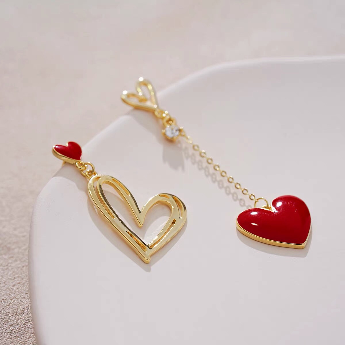 Big red heart-shaped earrings, long tassels, asymmetrical earrings, niche and elegant Jieya steel jewelry