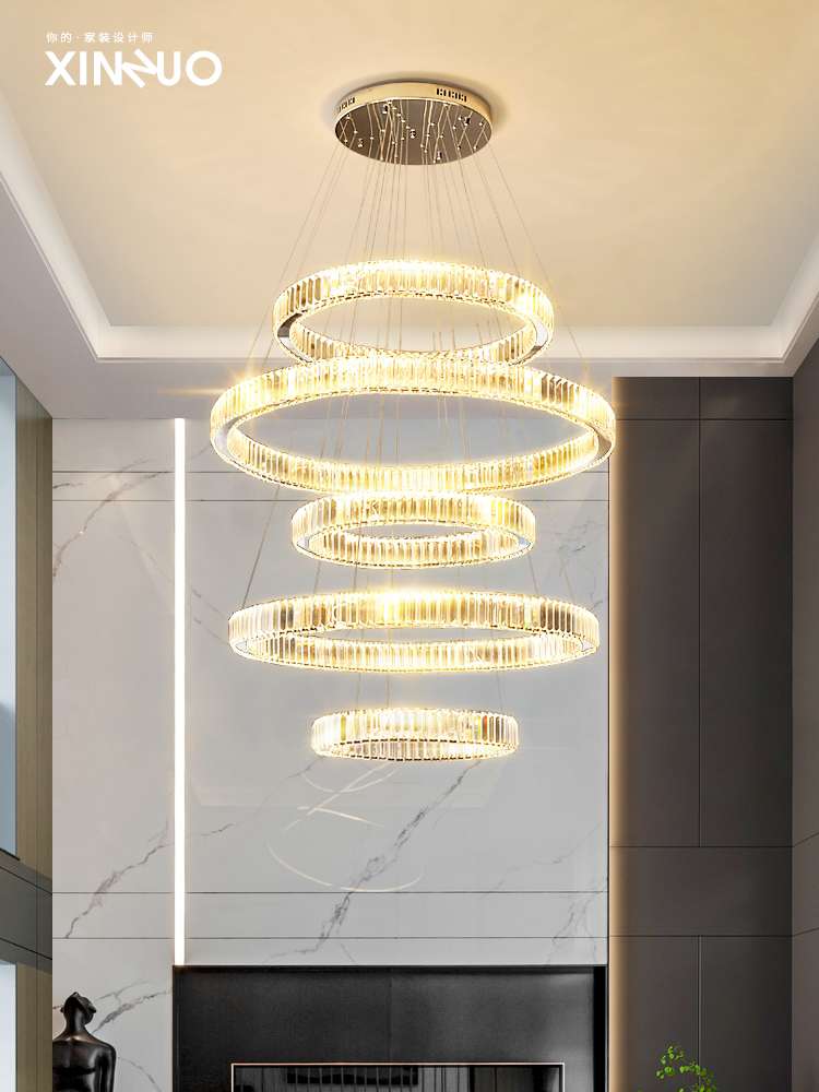 A large chandelier in the living room of a mezzanine building, modern and simple multi-story staircase lighting fixtures, a crystal chandelier in a duplex villa, gold details Picture
