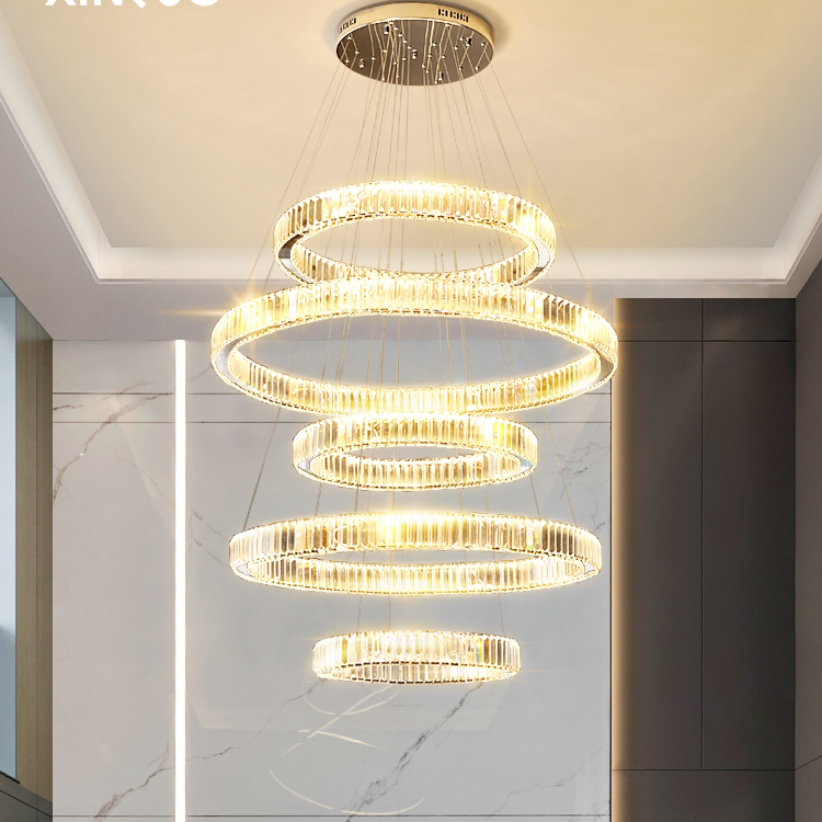 A large chandelier in the living room of a mezzanine building, modern and simple multi-story staircase lighting fixtures, a crystal chandelier in a duplex villa, gold