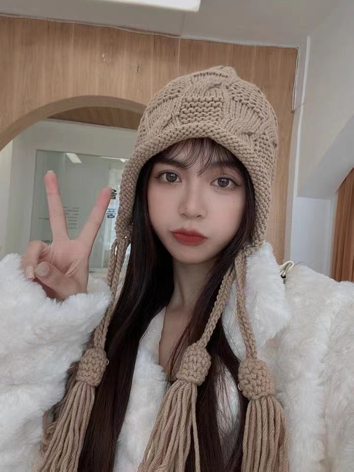 A Knitted Hat With Fringe