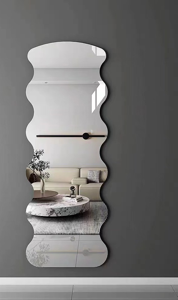 Irregular frameless wall mirror in modern living room setting