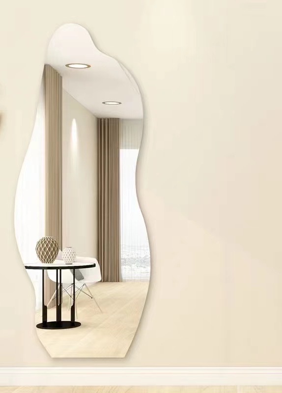 Close-up of irregular shaped thick mirror showing edge detail and reflection