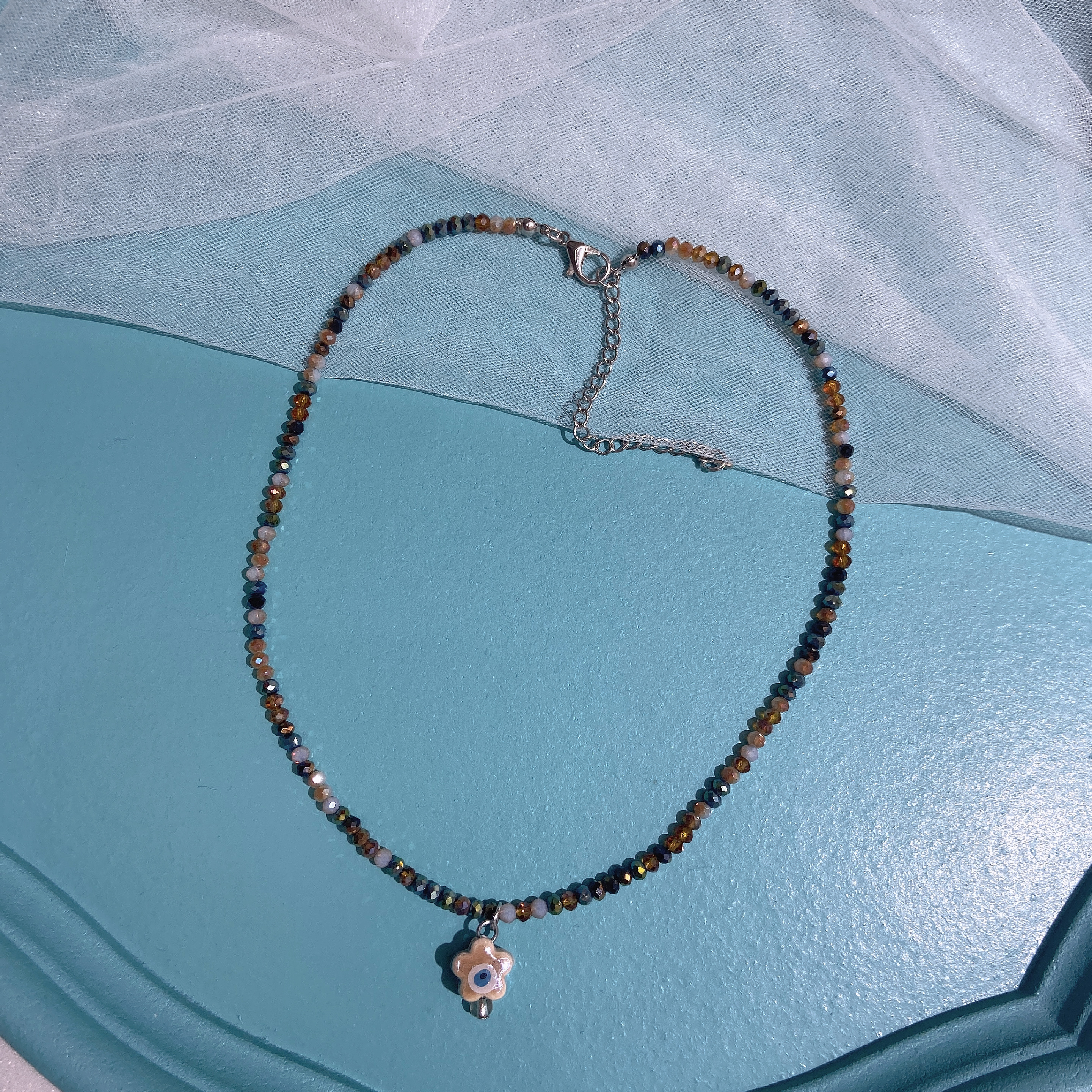 Hand-woven rice bead necklace with smiling face ceramic details Picture