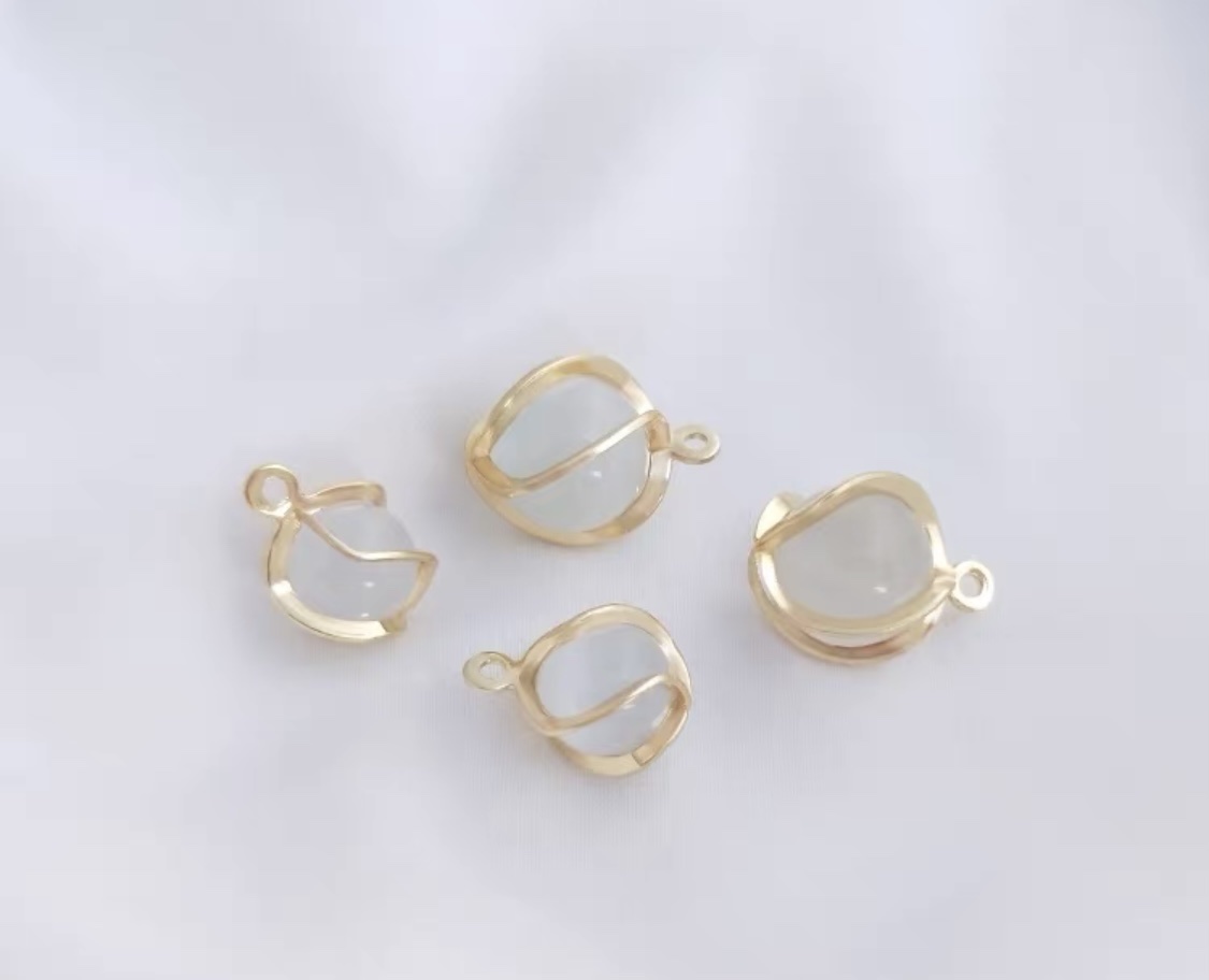 diy accessory, handcrafted bracelet, necklace and decorative pendant with a dynamic cat's eye stone bead around the cage details Picture
