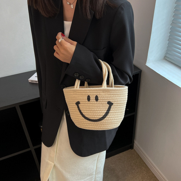 Wholesale of new hand-woven bags, emoticons, smiling straw woven bags and beach hand-held bucket bags Specification image
