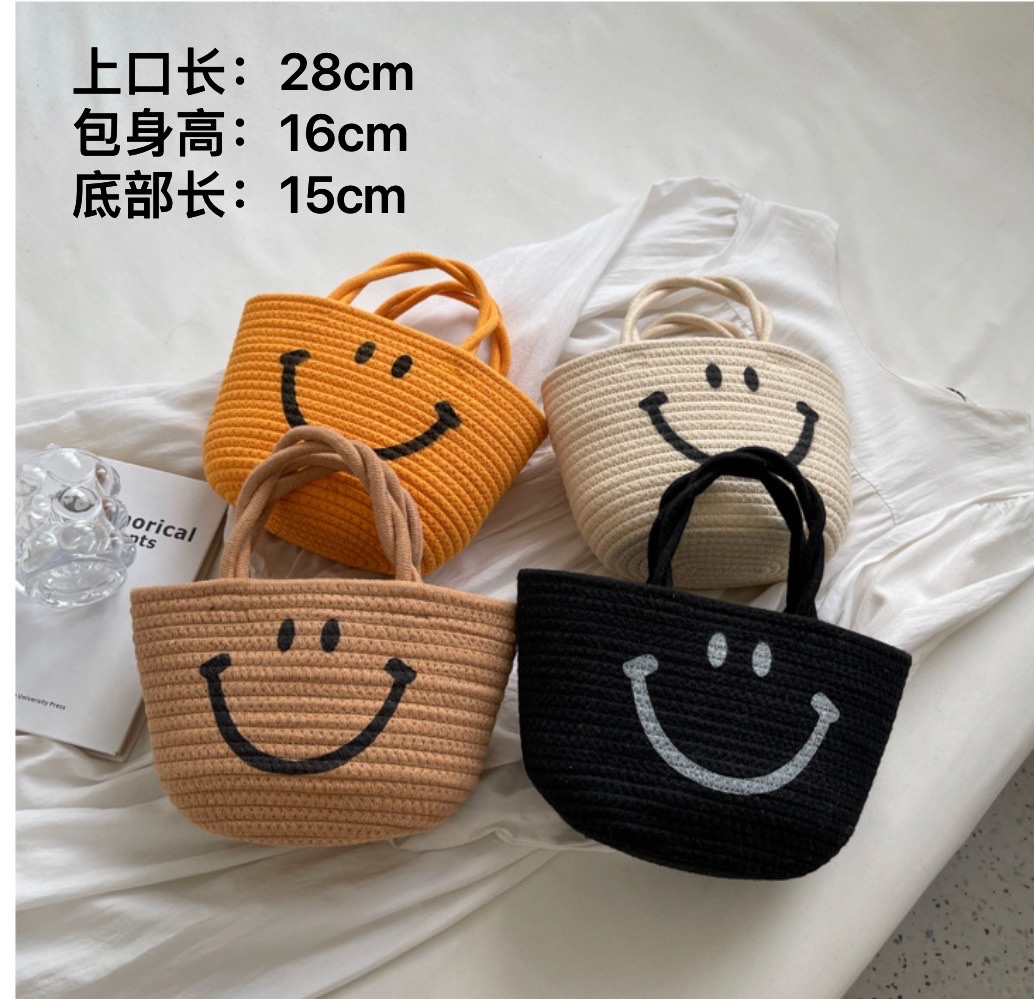 Wholesale of new hand-woven bags, emoticons, smiling straw woven bags and beach hand-held bucket bags details Picture