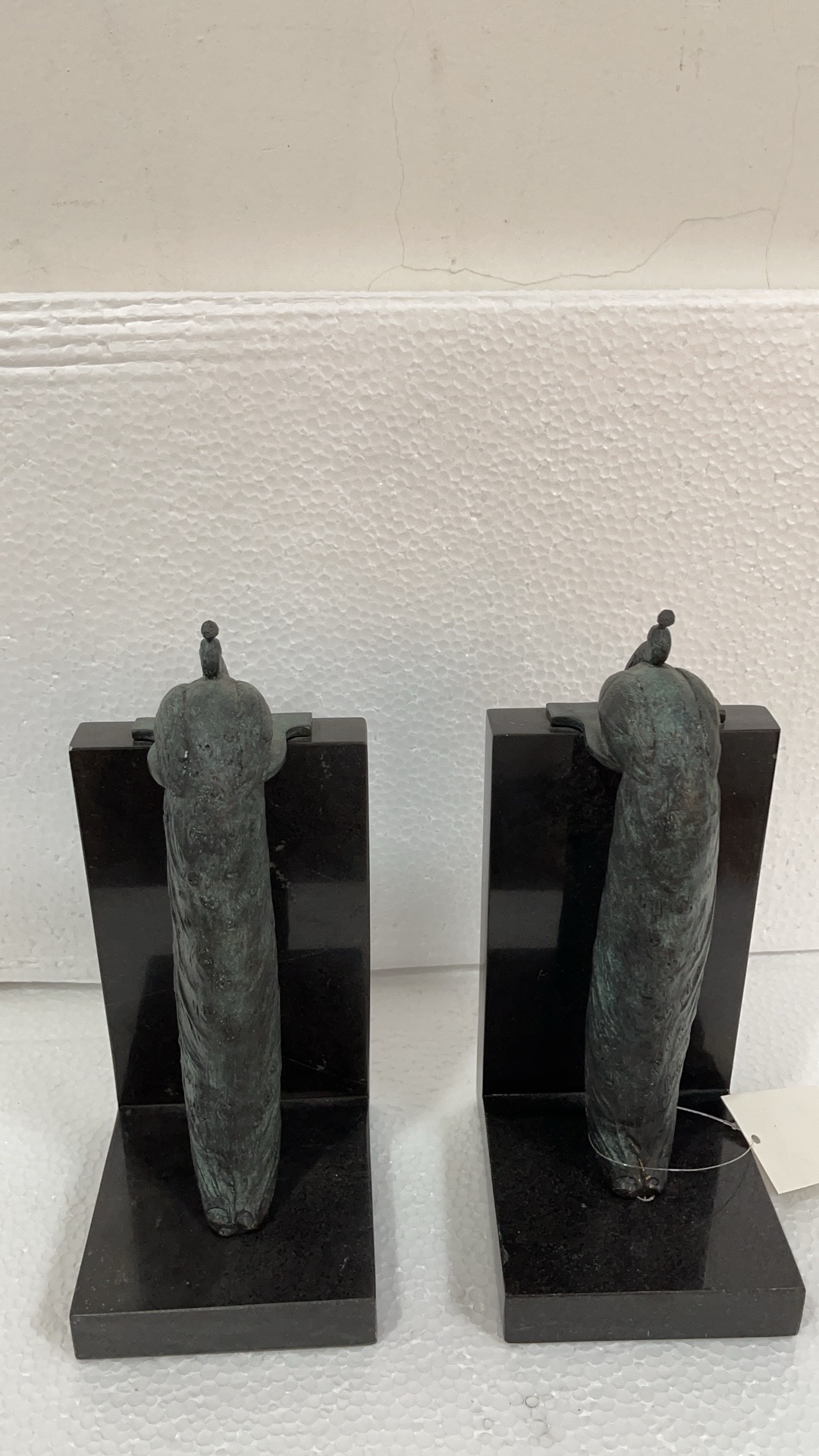 A copper decorative bookend stands on a copper peacock bookend Application Scenario