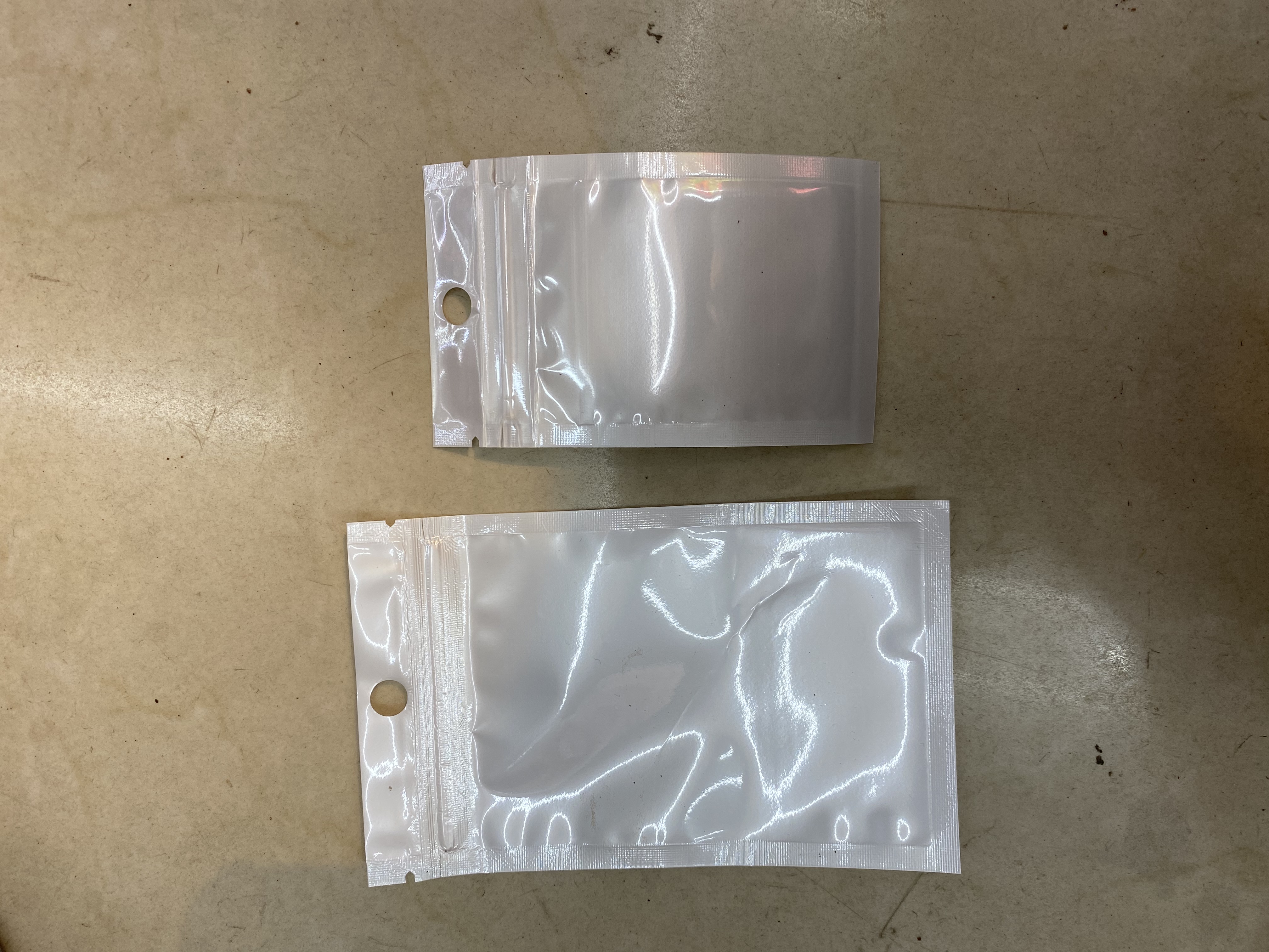 白色珠光膜阴阳自封袋子半透明耳机挂孔饰品拉骨袋密封塑料包装袋细节图