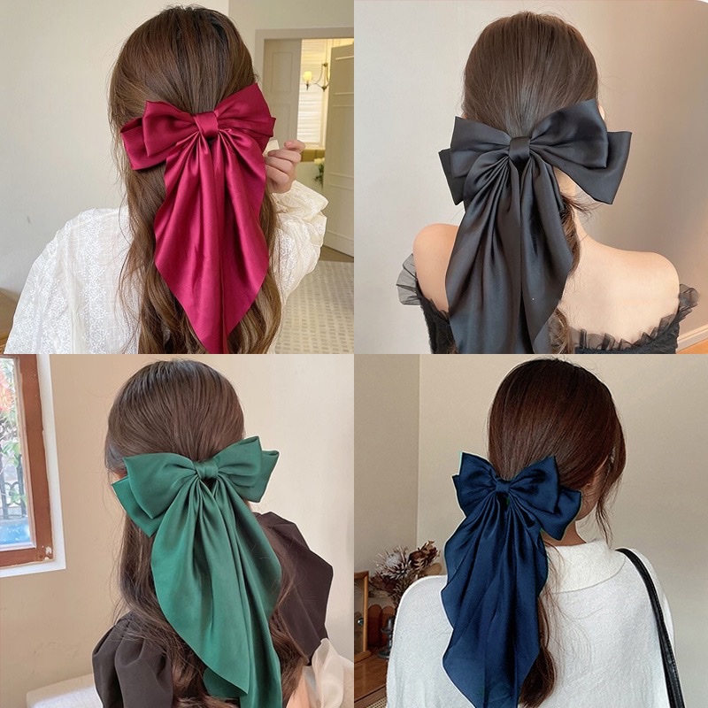 The new spring hairpin with a large red bow at the back of the head, a popular 2024 model, is a stylish headwear and hair accessory details Picture