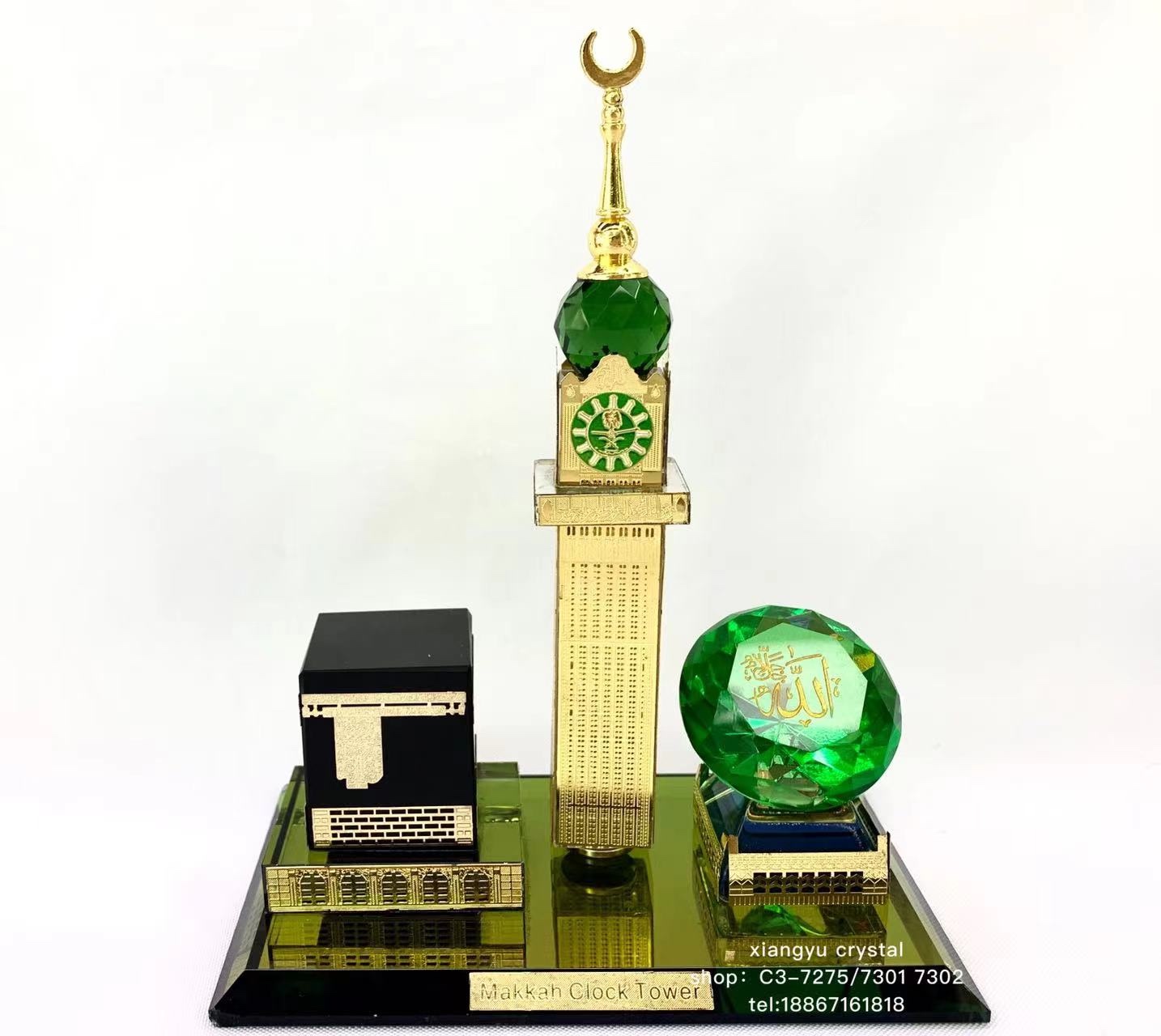 The glass handicraft ornament has a crystal base with a black house, on which there is a green diamond with a logo. There are two crystal pillars with metal rods added on top detail image 1
