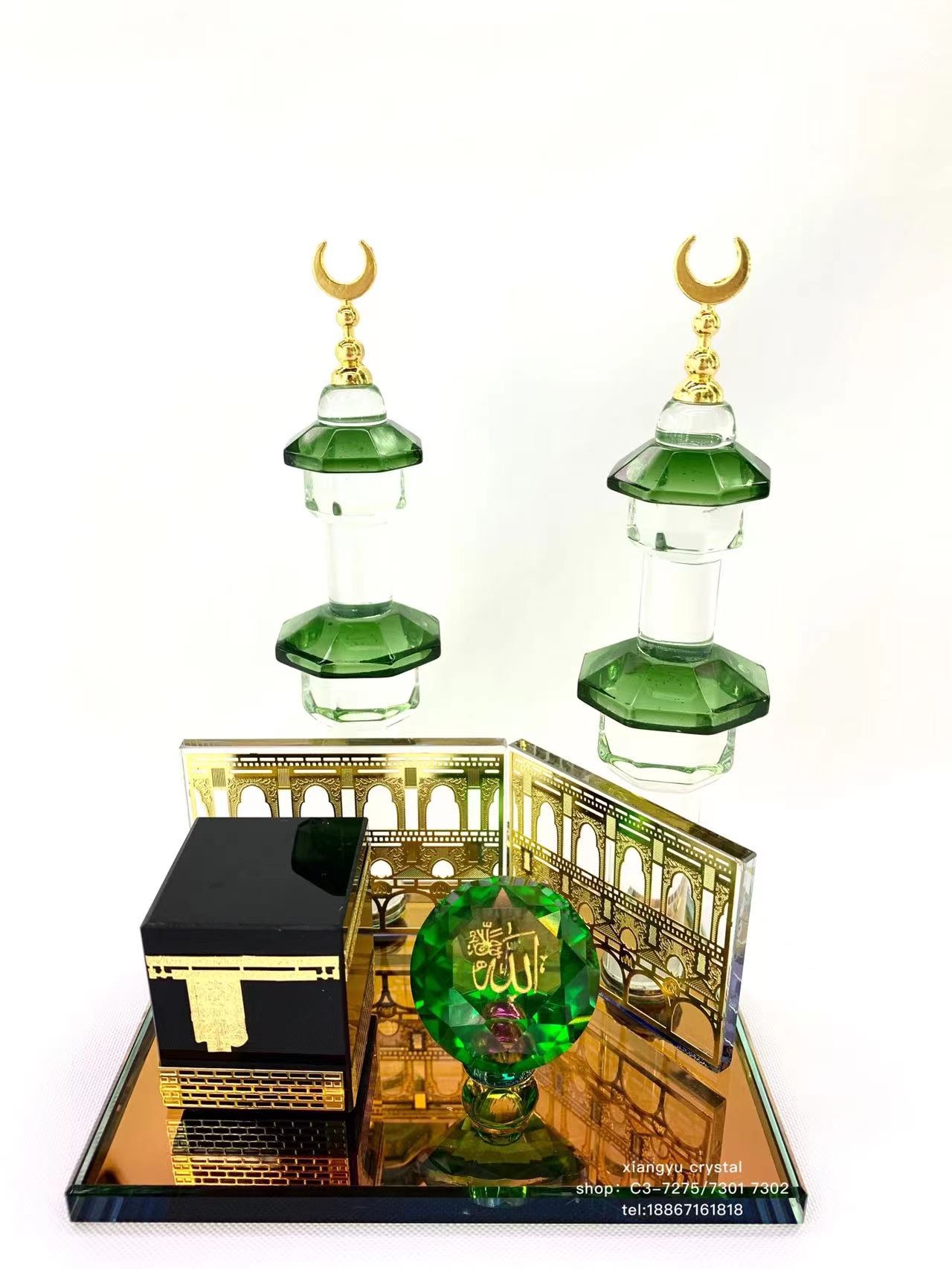 The glass handicraft ornament has a crystal base with a black house, on which there is a green diamond with a logo. There are two crystal pillars with metal rods added on top