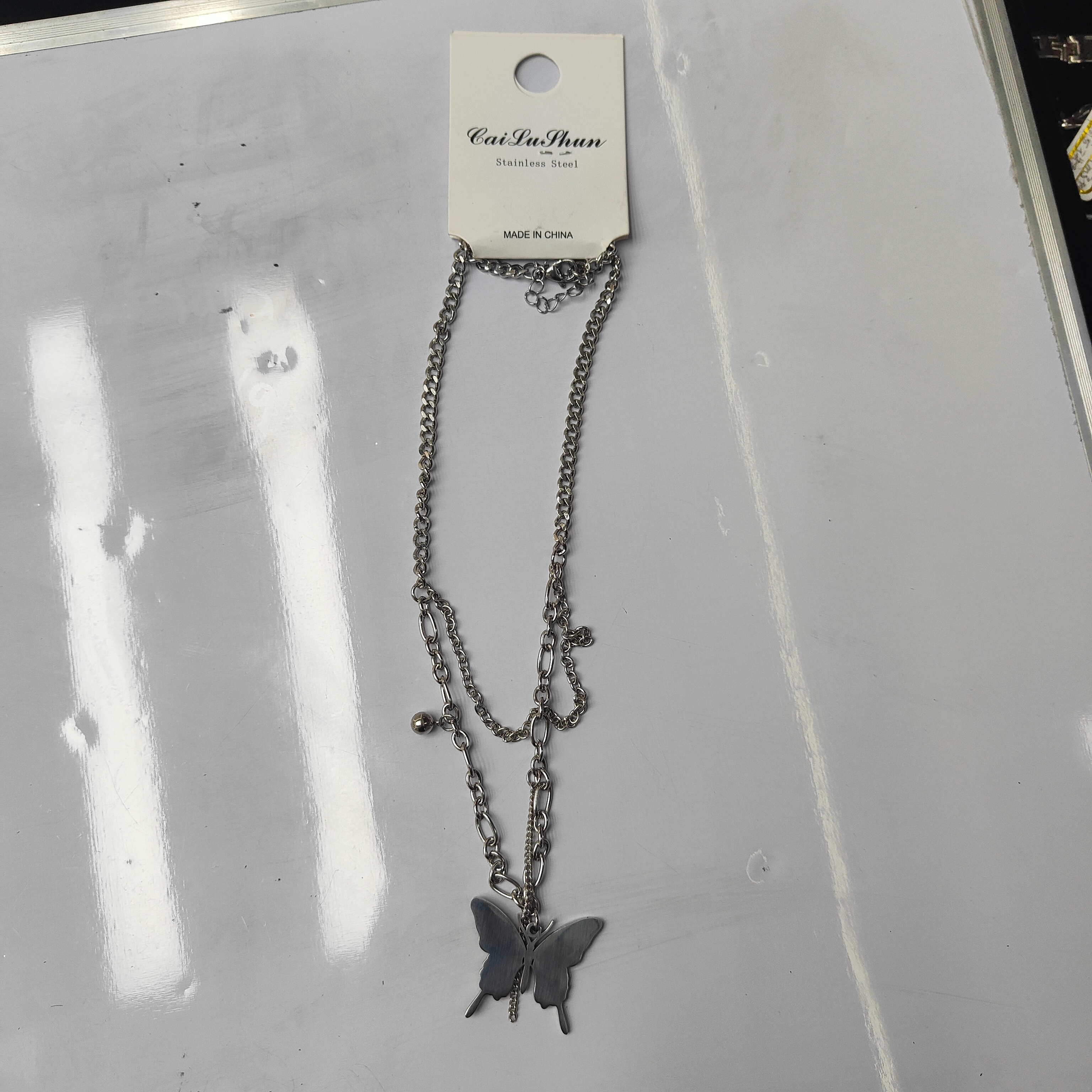A fashionable stainless steel bestseller, double-layered butterfly necklace, unisex chain tassel accessory for both men and women Application Scenario