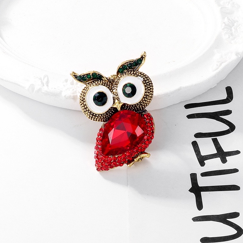 The Owl xi o Pokemon series rose brooch is decorated with blue zircon and features a zircon crown design that is exquisite and fashionable Item Picture