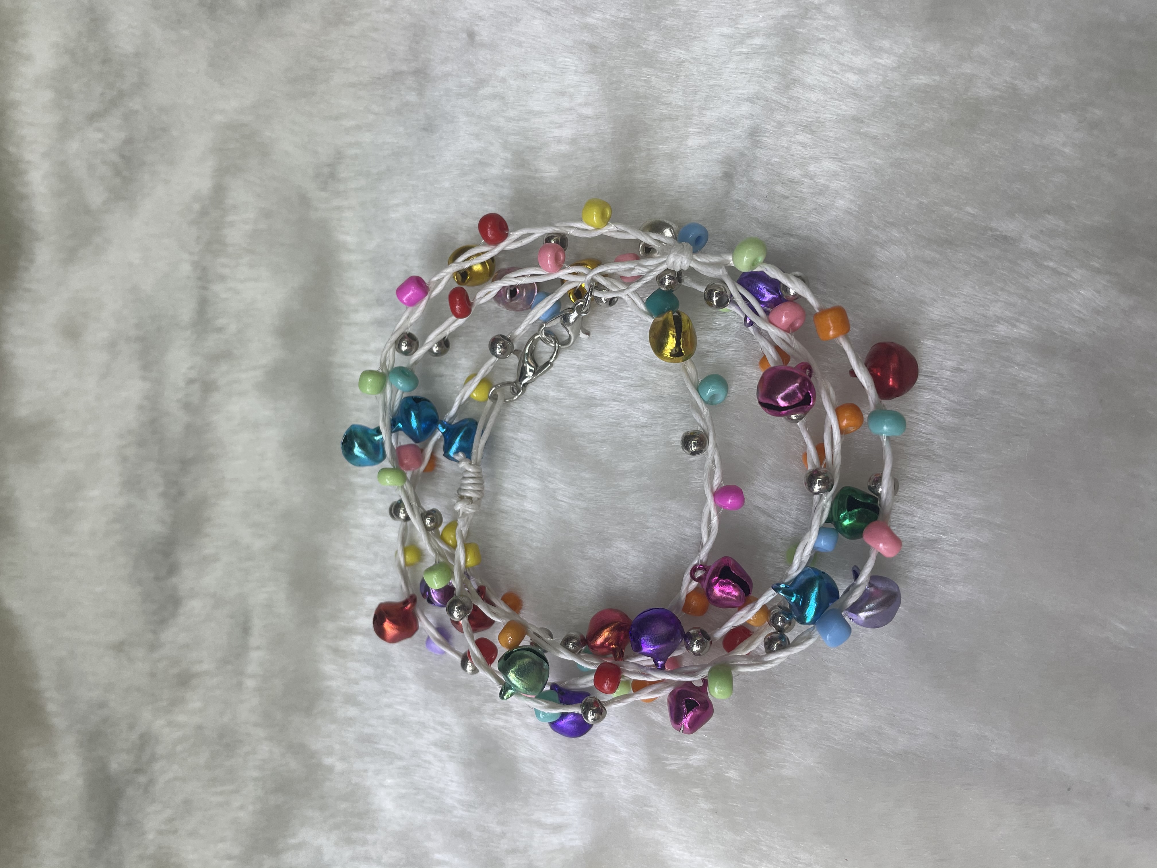 手工编织七彩铃铛加七彩米珠七十公分白拉绳项链幸运绳细节图